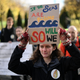 A woman holds up a placard at the start of a "Pilgrims Procession" an opening ceremony to a series of non-violent direct actions being organised by the Extinction Rebellion climate activist action group near the Scottish Event Centre (SEC) in Glasgow, Scotland on October 30, 2021, venue of the COP26 UN Climate Change Conference to be held in the city from October 31. - Pilgrimage groups and artists, including members of XR Faith, are walking to Glasgow to raise awareness of the climate crisis and demand a fair deal at COP26 for the Global South as Britain hosts more than 120 leaders in Glasgow, before the UN meeting spends a fortnight tackling the work of deciding how to limit temperature rises to 1.5 degrees Celsius. (Photo by DANIEL LEAL-OLIVAS / AFP) (Photo by DANIEL LEAL-OLIVAS/AFP via Getty Images)